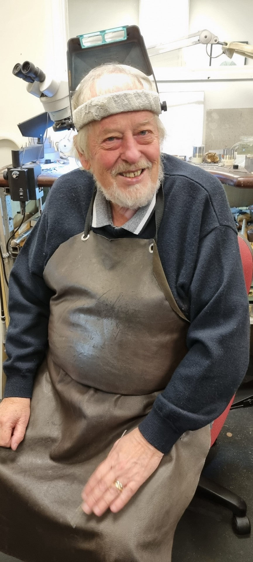 Smiling man wearing leather apron