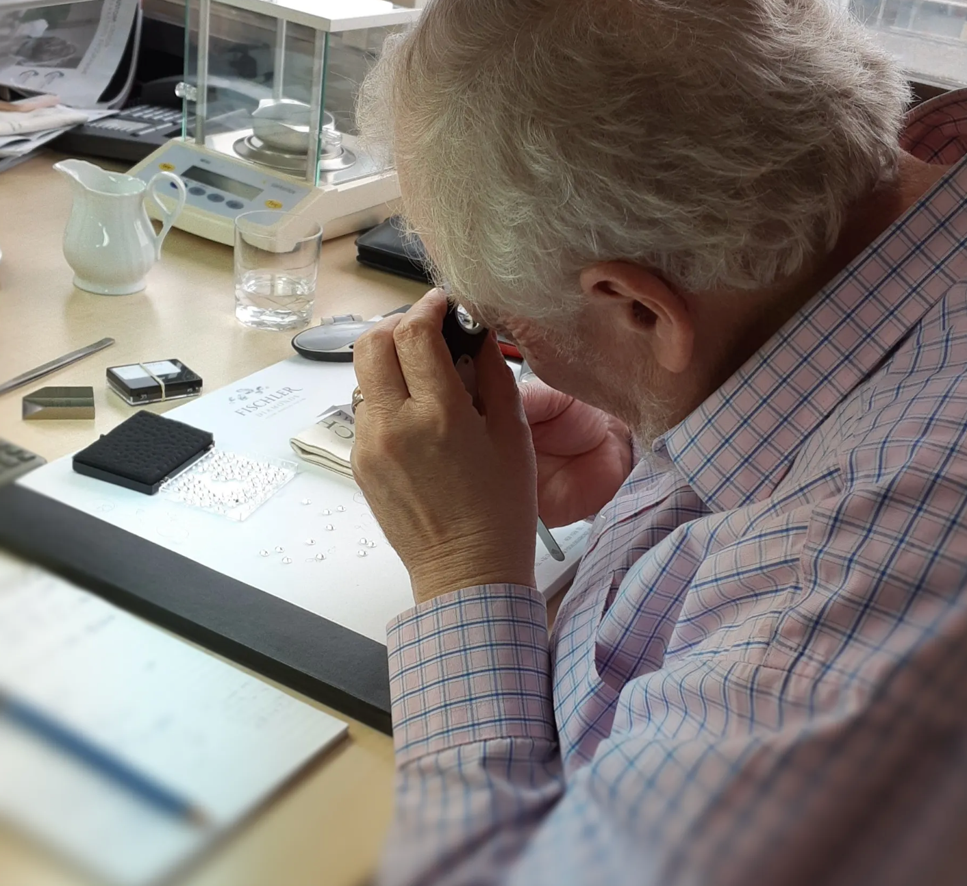 Man inspecting loose diamonds